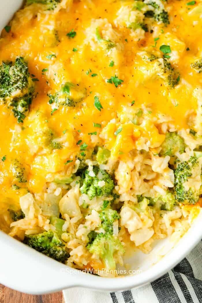 Hearty broccoli cheese rice casserole with a golden cheese top and visible rice grains in a serving dish